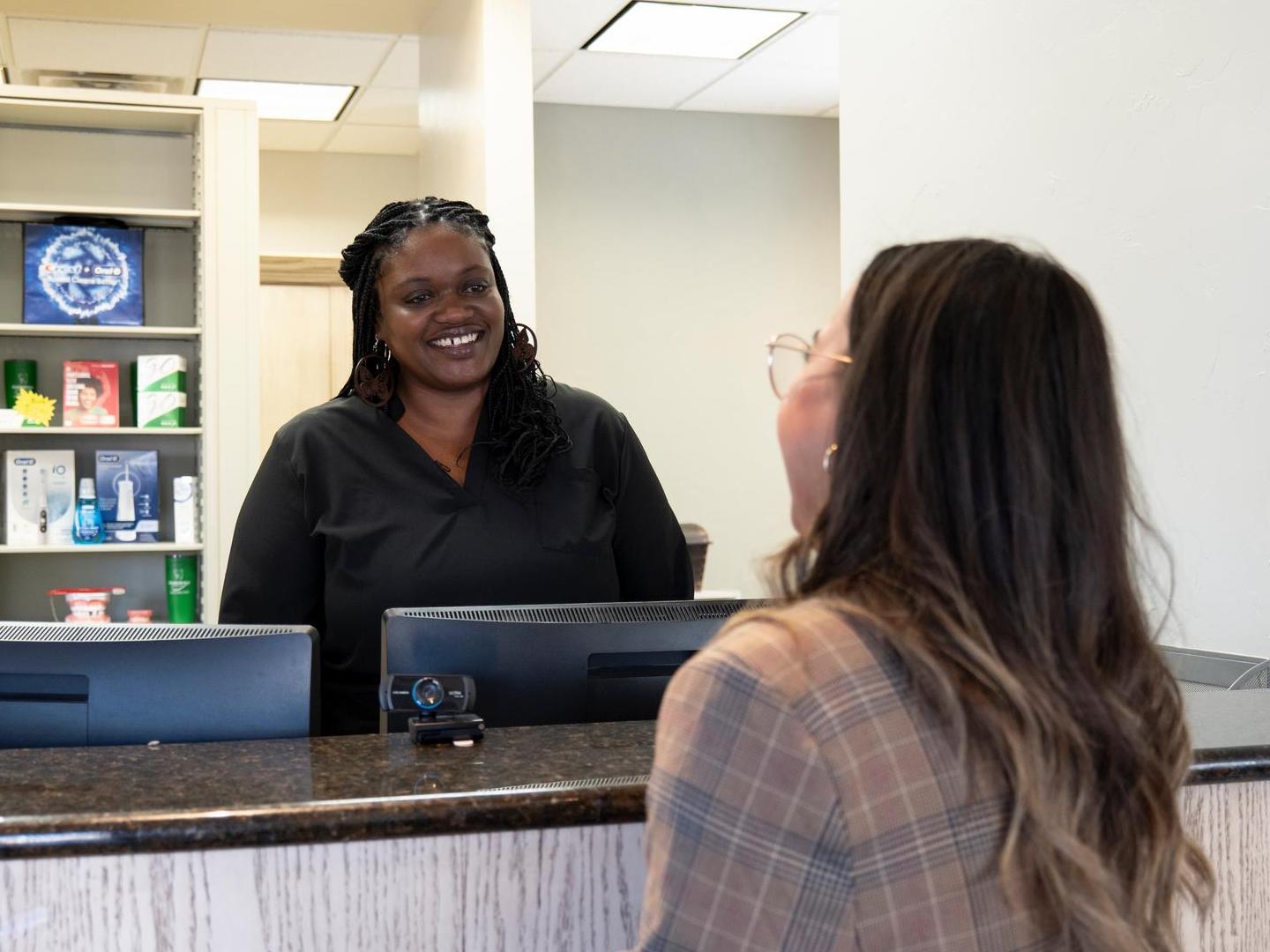 Receptionist greeting patient